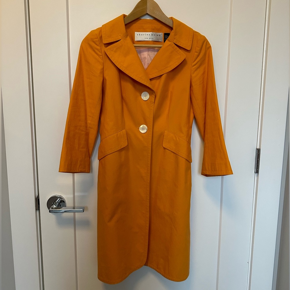 Like new Charles Nolan trench.  Orange exterior with light pink interior lining.